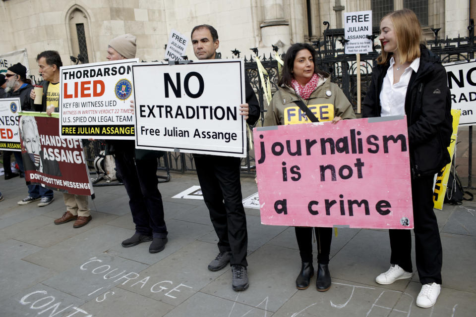 Julian Assange supporters gather outside the High Court in London, Thursday, Oct. 28, 2021. The U.S. government is this week asking Britain's High Court to overturn a judge's decision that WikiLeaks founder Julian Assange should not be sent to the United States to face espionage charges. A lower court judge refused extradition in January on health grounds, saying Assange was likely to kill himself if held under harsh U.S. prison conditions. (AP Photo/David Cliff)