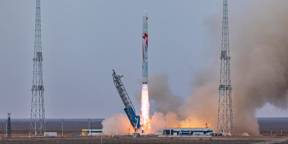 China's LandSpace Zhuque-2 rocket launches off, leaving behind a blue yellow flame.