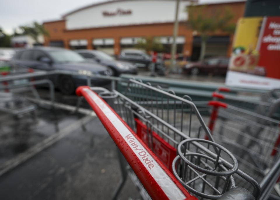 A Winn Dixie shopping cart is seen in the parking lot of the Palm Harbor, Fla., store Wednesday, Aug. 16, 2023. Discount grocer Aldi said Wednesday it plans to buy 400 Winn-Dixie and Harveys supermarkets in the southern U.S. (Chris Urso/Tampa Bay Times via AP)