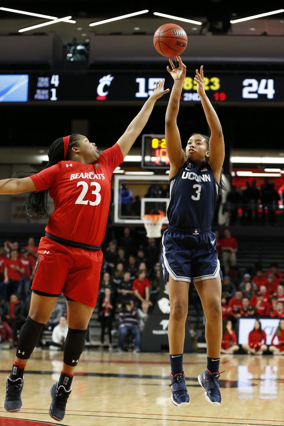 Connecticut forward Megan Walker (3) shoots over Cincinnati forward Iimar'i Thomas (23) during the first half of an NCAA college basketball game Wednesday, Feb. 26, 2020, in Cincinnati. (AP Photo/Gary Landers)