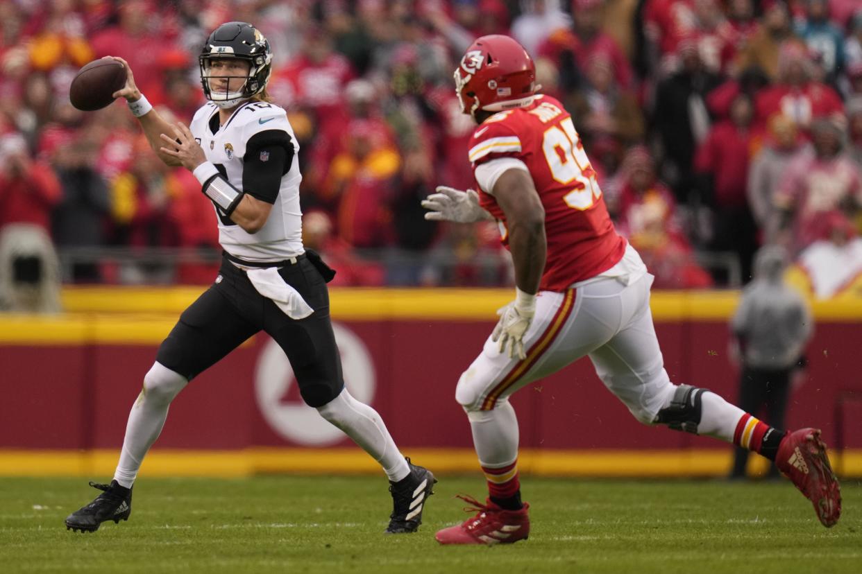 Jacksonville Jaguars quarterback Trevor Lawrence (16) looks to pass under pressure by Kansas City Chiefs defensive tackle Chris Jones (95) during the first half of an NFL divisional round playoff football game, Saturday, Jan. 21, 2023, in Kansas City, Mo. (AP Photo/Jeff Roberson)