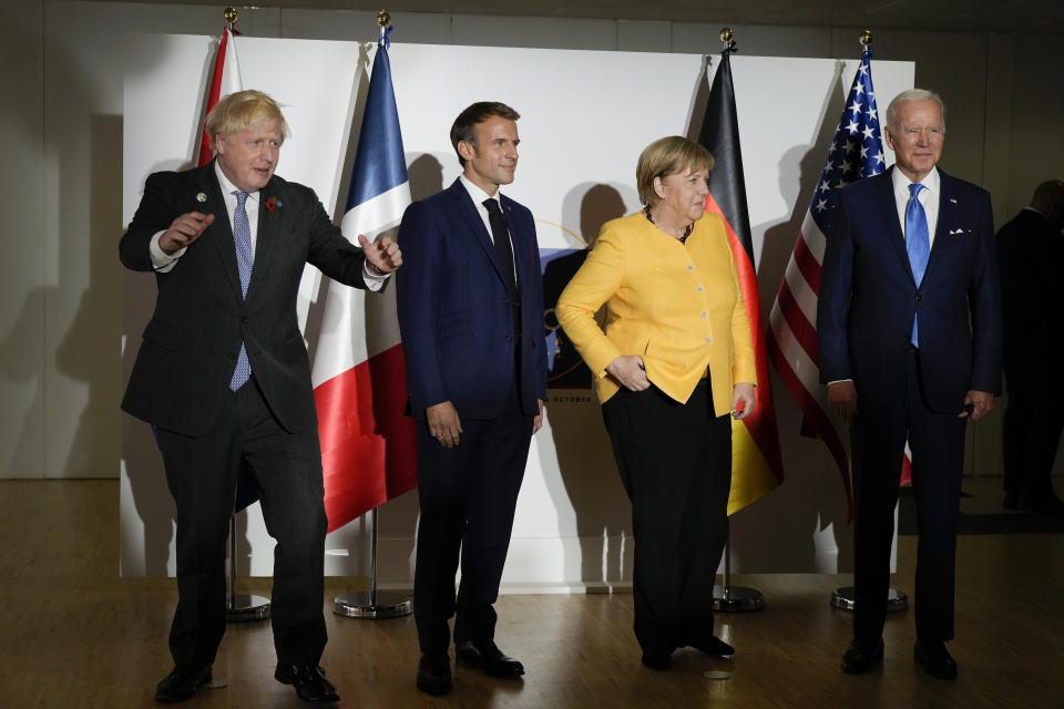 British Prime Minister Boris Johnson, French President Emmanuel Macron, German Chancellor Angela Merkel, and U.S. President Joe Biden, from left, pose for the media prior to a meeting at the La Nuvola conference center for the G20 summit in Rome, Saturday, Oct. 30, 2021. The two-day Group of 20 summit is the first in-person gathering of leaders of the world's biggest economies since the COVID-19 pandemic started. (AP Photo/Kirsty Wigglesworth, Pool)