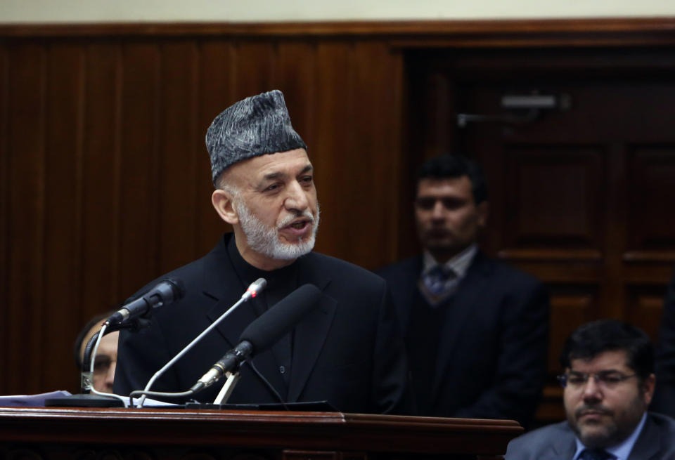 Afghan President Hamid Karzai speaks during his final address to parliament during its opening session at the parliament house in Kabul, Afghanistan, Saturday, March 15, 2014. Karzai said the last 12 years of war were "imposed" on Afghans, a reference to the U.S.-led invasion that ousted the Taliban. (AP Photo/Rahmat Gul)