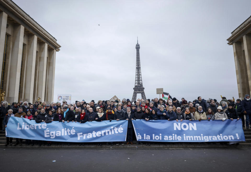 FILE - Opponents of France's immigration law protest with banners that read, "Freedom, equality, fraternity" and "no to the immigration law" at Trocadero Plaza near Eiffel Tower in Paris, Sunday, Jan. 21, 2024. European Union nations will discuss on Tuesday, May 14, 2024, sweeping new reforms to the bloc's failed asylum system as campaigning for Europe-wide elections next month gathers pace, with migration expected to be an important issue. (AP Photo/Thomas Padilla, File)