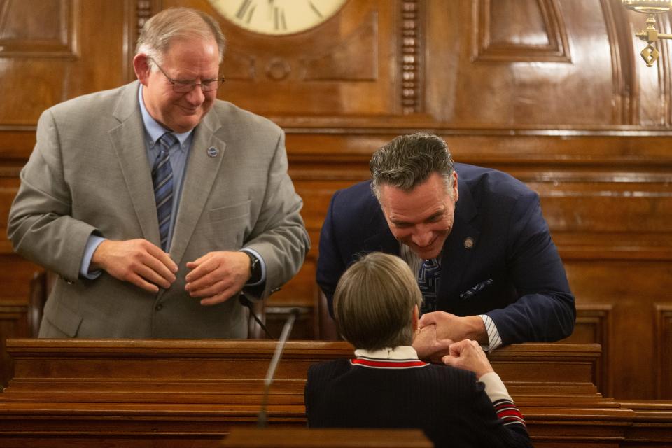 Gov. Laura Kelly motions towards Senate President Ty Masterson, R-Andover, as she exchanges words with him and House Speaker Dan Hawkins, R-Wichita, left, before her State of the State address. The trio negotiated a compromise tax cut plan passed during Tuesday's special session.