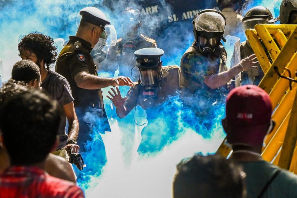 Police use tear gas to disperse students demanding the resignation of Sri Lankan president Gotabaya Rajapaksa over the country’s crippling economic crisis in Colombo on 21 May (AFP via Getty)