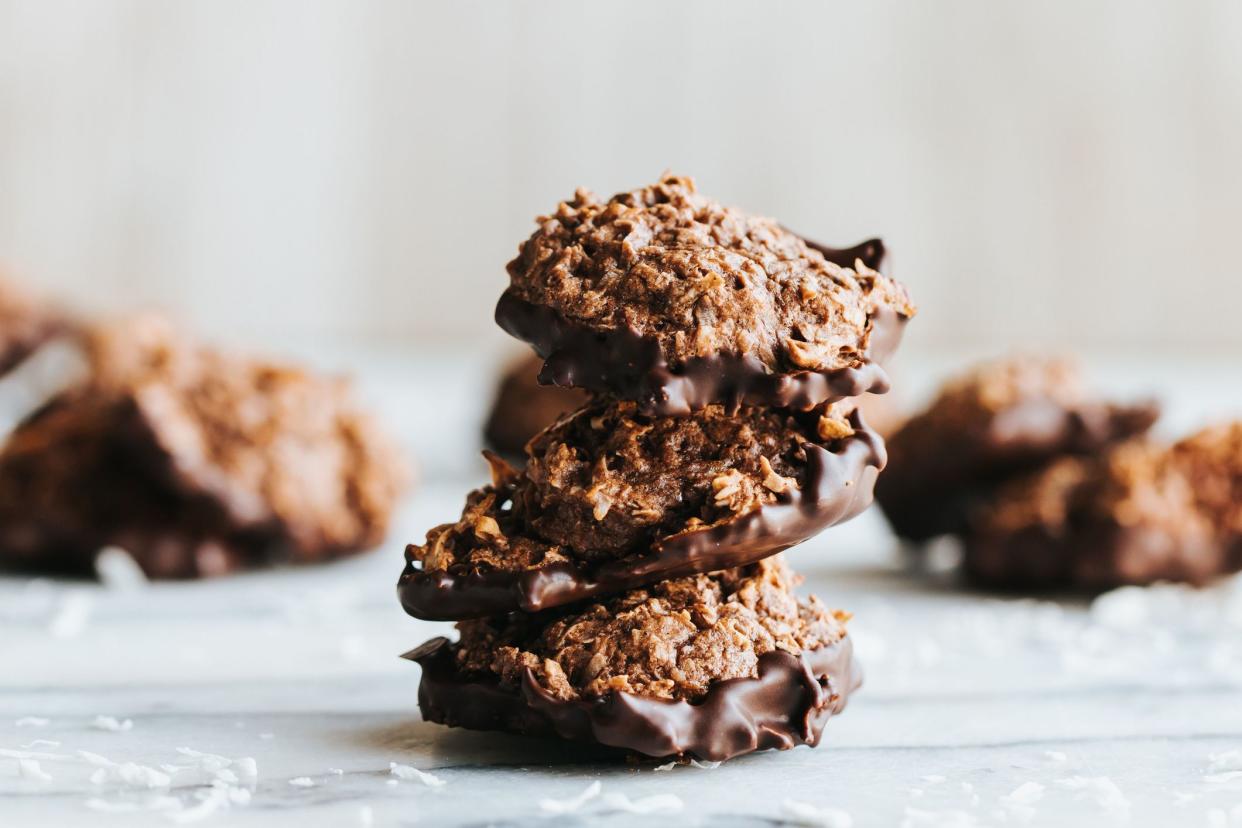 A closeup shot of a stack of no bake cookies dipped in chocolate on the marble kitchen counter