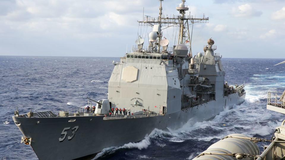 The guided-missile cruiser Mobile Bay sails alongside the aircraft carrier Abraham Lincoln for refueling in the Philippine Sea Feb. 26, 2022. (MCSN Aleksandr Freutel/Navy)