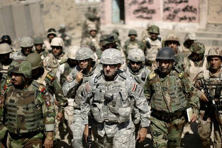 Major-General Mark Hertling (C), the commander of the U.S. forces in northern Iraq, walks during a battlefield circulation patrol on the streets in Mosul in this June 19, 2008 file photo. REUTERS/Eduardo Munoz/Files