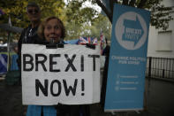 A pro-Brexit leave the European Union supporter holds a placard opposite the Houses of Parliament in London, Thursday, Oct. 24, 2019. Britain's Prime Minister Boris Johnson won Parliament's backing for his exit deal on Wednesday, but then lost a key vote on its timing, effectively guaranteeing that Brexit won't happen on the scheduled date of Oct. 31. (AP Photo/Matt Dunham)