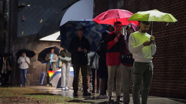 PHOTO: Local residents wait in line to cast their ballot during the runoff U.S. Senate election between Democratic Senator Raphael Warnock and his Republican challenger Herschel Walker in Atlanta, on Dec. 6, 2022. (Carlos Barria/Reuters)