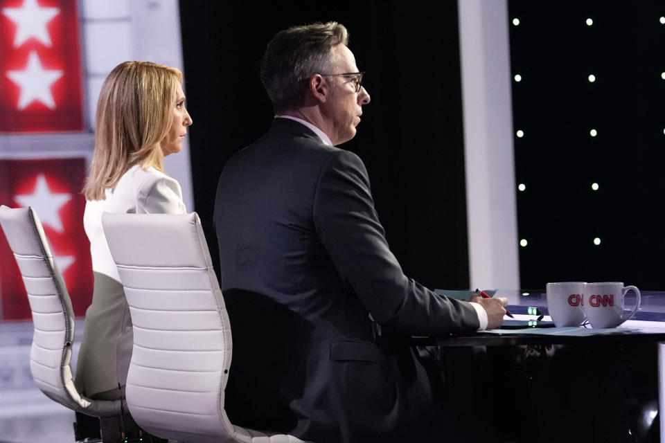 FILE _ CNN's Dana Bash, left, and Jake Tapper listen as they moderate a presidential debate between President Joe Biden and Republican presidential candidate former President Donald Trump, Thursday, June 27, 2024, in Atlanta. There were exhaustive, independent fact-checks of claims made during the CNN debate between Joe Biden and Donald Trump on Thursday, June 27, but none available to the millions of people watching the two presidents in real time. (AP Photo/Gerald Herbert, File)