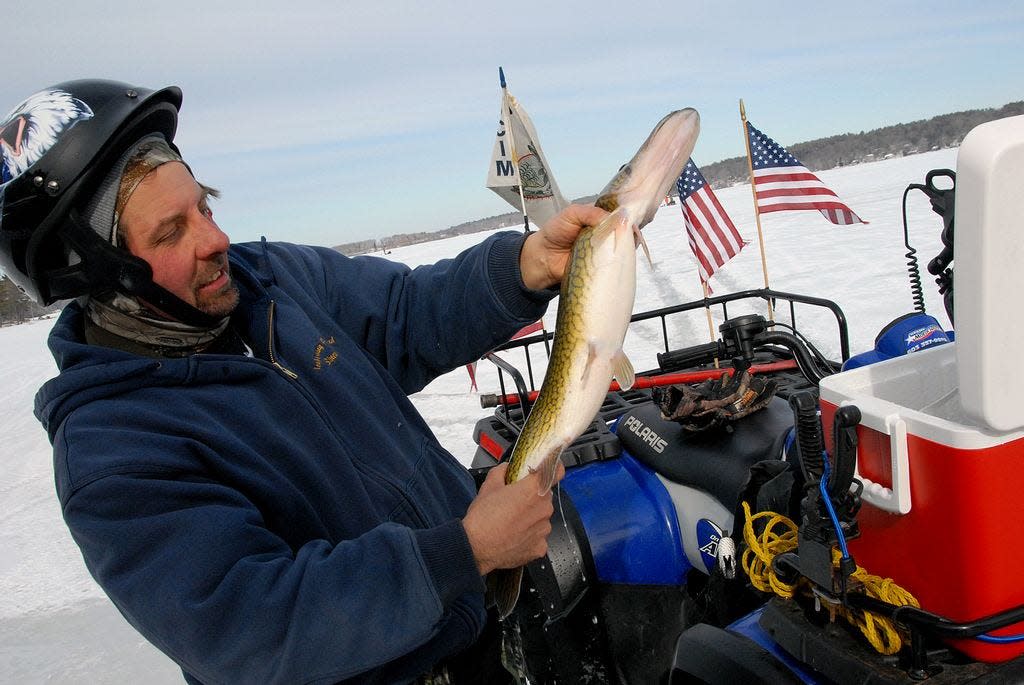 Joe Wood holds a pickerel caught during a past Bristol County Ice Masters Ice Fishing Tournament on Long Pond in Lakeville.