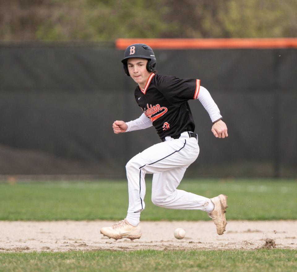 Carter Gregg of Brighton dodges an infield hit on his way to second base against Howell Wednesday, May 4, 2022.