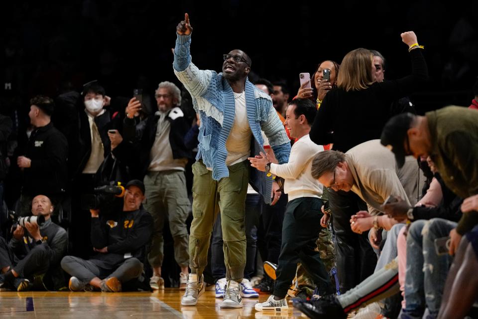 Former NFL player Shannon Sharpe, center, stands up during the second half an NBA basketball game between the Memphis Grizzlies and the Los Angeles Lakers in Los Angeles, Friday, Jan. 20, 2023. At halftime, Sharpe confronted Memphis Grizzlies forward Dillon Brooks and center Steven Adams. (AP Photo/Ashley Landis)