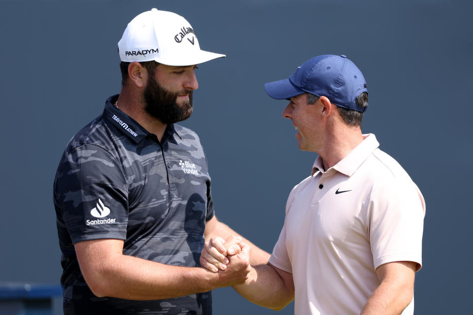 Jon Rahm of Spain shakes hands with Rory McIlroy of Northern Ireland on the 1st tee on Day One of The 151st Open at Royal Liverpool Golf Club on July 20, 2023 in Hoylake, England. (Photo by Warren Little/Getty Images)