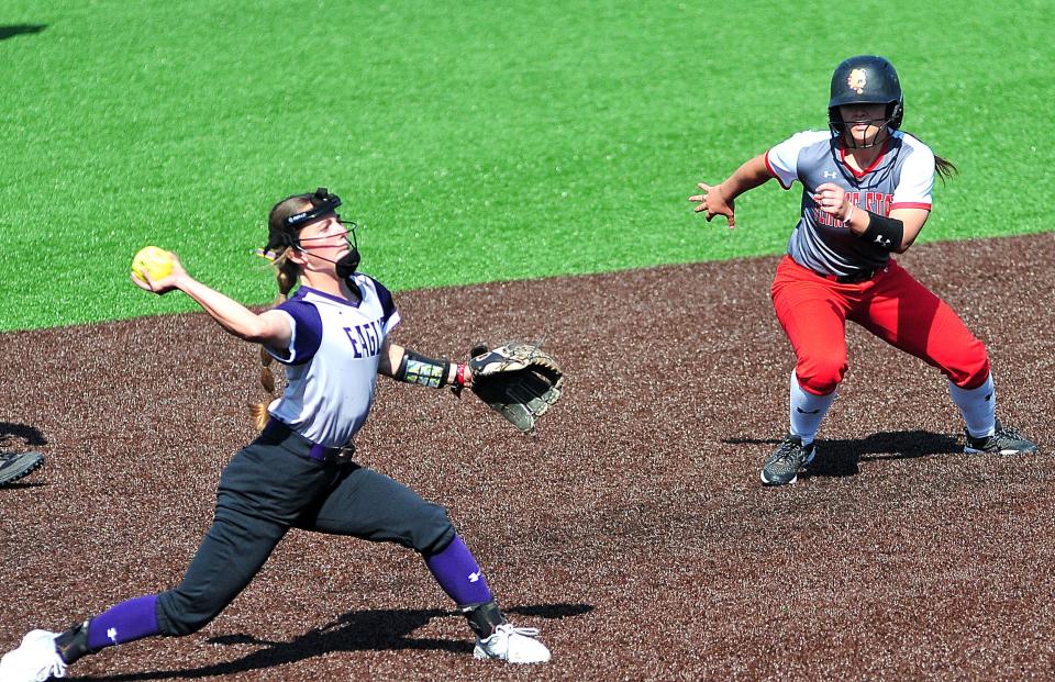 Ferris State University’s Kacey Bouche (16) runs to third base as  Ashland University’s Ashley Veldheer (11)throws to first base during softball Tuesday, April 11, 2023 at Ashland University’s Deb Miller Field at Archer Ballpark Complex.