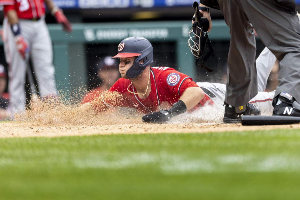 Washington Nationals' Carter Kieboom (8) scores before Philadelphia Phillies catcher Rafael Marchan can make the tag during the third inning of a baseball game, Thursday, July 29, 2021, in Philadelphia in the second game of a doubleheader. (AP Photo/Laurence Kesterson)