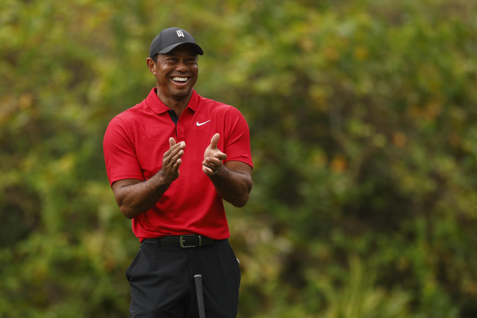 Tiger Woods reacts after his son, Charlie Woods, chips in for a birdie on the ninth green during the final round of the PNC Championship at The Ritz-Carlton Golf Club on Dec. 17, 2023 in Orlando. (Photo by Mike Ehrmann/Getty Images)