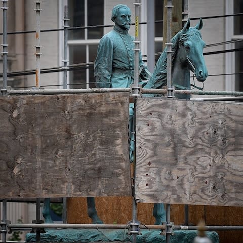 A monument to Confederate General John Hunt Morgan stands encased in a protective scaffolding because of local construction, outside the Historic Lexington Courthouse in Lexington - Credit: Reuters