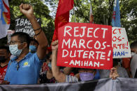 Activists protest against presidential frontrunner Ferdinand "Bongbong" Marcos and running mate Sara Duterte, daughter of the current president, during a rally at the Commission on Human Rights in Quezon City, Metro Manila, Philippines on Wednesday. May 25, 2022. Marcos Jr. continues to lead in the official canvassing of votes. (AP Photo/Basilio Sepe)