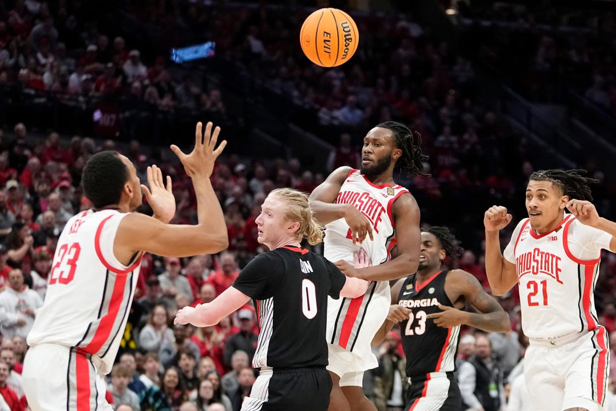 Mar 26, 2024; Columbus, OH, USA; Ohio State Buckeyes guard Bruce Thornton (2) passes over Georgia Bulldogs guard Blue Cain (0) to forward Zed Key (23) during the second half of the NIT quarterfinals at Value City Arena. Ohio State lost 79-77.