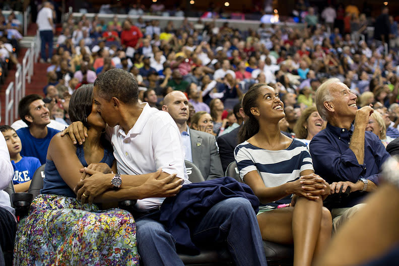 <b>July 16, 2012:</b> "The President and First Lady were attending the game between the U.S. Men's Olympic basketball team and Brazil in Washington, D.C. During the first half, the jumbotron flashed couples on their 'Kiss Cam', where they are then induced by the crowd to kiss each other. But neither the President or First Lady saw themselves when they were flashed on the 'Kiss Cam', and some in the audience booed when they didn't kiss. At halftime, as we walked to the locker room to visit the U.S. team, daughters Malia and Sasha were asking their parents why they hadn't kissed during their 'Kiss Cam' moment. Both the President and First Lady said they hadn't even realized what had happened and didn't know why people were booing. So in the second half, when they appeared again on the 'Kiss Cam', the President leaned over to kiss the First Lady amongst audience cheers as Malia and the Vice President watched overhead on the jumbotron." (Official White House Photo by Pete Souza)