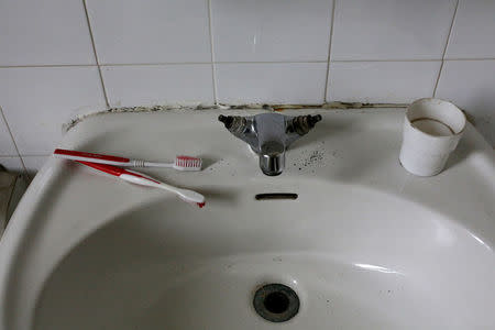 Toothbrushes are seen on a sink inside a bathroom at the Cavallerizza Reale building, which is occupied by the "Assemblea Cavallerizza 14:45" movement in Turin, Italy July 22, 2016. REUTERS/Marco Bello
