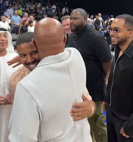 <p>NBA/Instagram</p> Michael B. Jordan and Steve Harvey share a hug at NBA Abu Dhabi Games 2023.