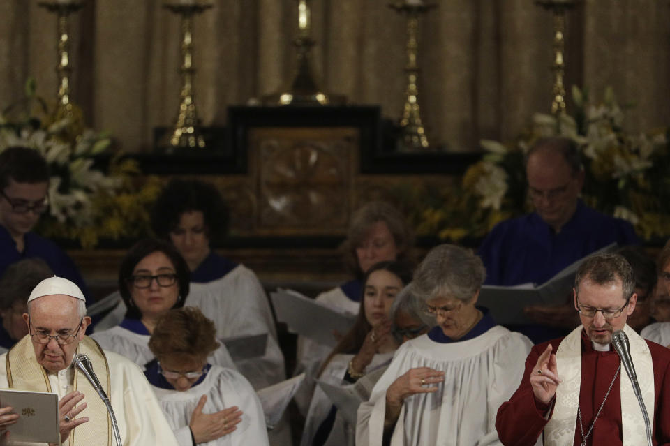 Pope Francis and reverend Robert Innes, right, the Anglican Bishop in Europe, pray during a ceremony of blessing of an icon of Christ the Saviour by English artist Ian Knowles, during his historic visit to the Anglican Church of All Saints in Rome, Sunday, Feb. 26, 2017. (AP Photo/Gregorio Borgia)