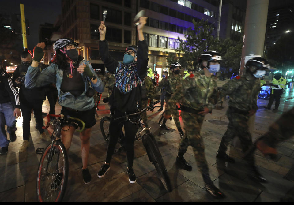 Opponents of former President Alvaro Uribe celebrate in downtown Bogota, Colombia, Tuesday, Aug. 4, 2020. Uribe will not be allowed to remain at liberty while the Supreme Court investigates allegations of witness tampering against him, current President Ivan Duque said in in a video address Tuesday after the former president said on Twitter he was being deprived of his freedom. (AP Photo/Fernando Vergara)