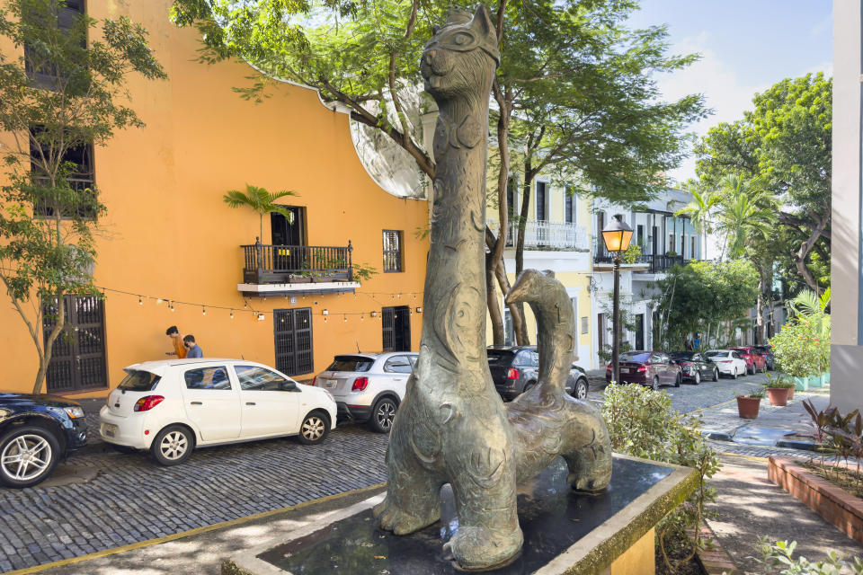 A statue of a cat stands in Old San Juan, Puerto Rico, Thursday, Nov. 3, 2022. Cats have long strolled through the cobblestone streets of the historic district and are so beloved they even have their own statue in Old San Juan. (AP Photo/Alejandro Granadillo)