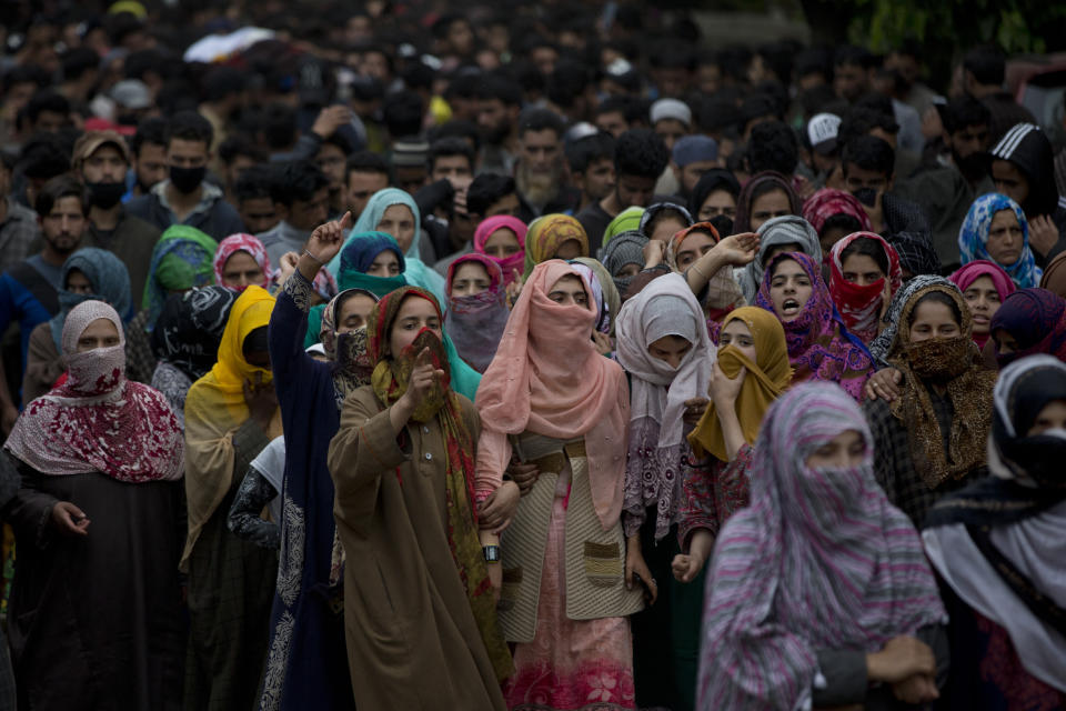 Kashmiri village women shout pro freedom slogans as they participate in funeral procession of top rebel commander Naseer Pandith, in Pulwama, south of Srinagar, Indian controlled Kashmir, Thursday, May 16, 2019. Three rebels, an army soldier and a civilian were killed early Thursday during a gunbattle in disputed Kashmir that triggered anti-India protests and clashes, officials and residents said. (AP Photo/ Dar Yasin)