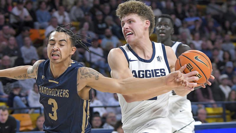 Utah State guard Mason Falslev, front right, drives to the basket as South Dakota School of Mines guard Alejandro Rama (3) defends during the second half of an NCAA college basketball game Monday, Nov. 6, 2023, in Logan, Utah. (Eli Lucero/Herald Journal via AP)