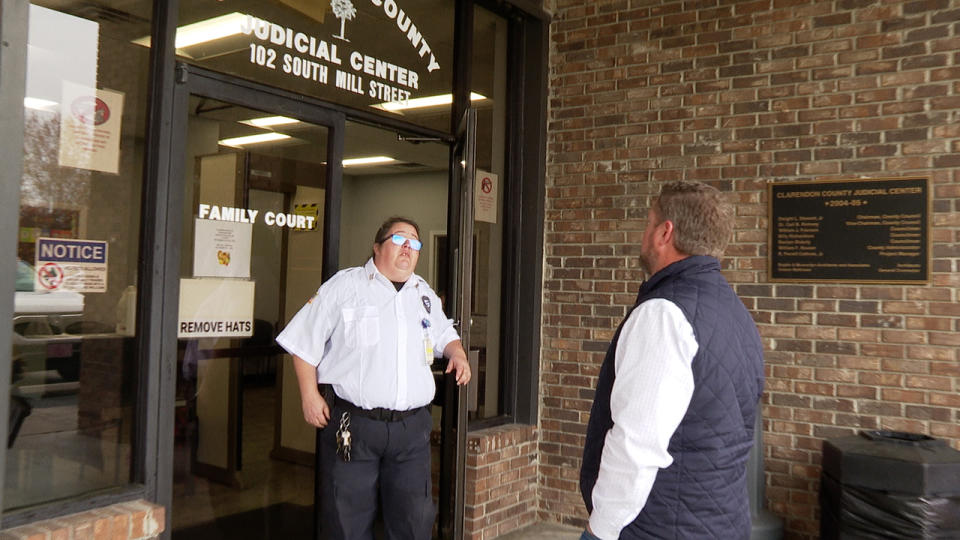 This armed private security guard met us at the front door of the Clarendon County Magistrate’s Office, blocking us from entering the public courthouse with a news camera. The guard said she received her orderds from Susie McDowell, the clerk’s office’s deputy clerk. (WJZY Photo/Ryan Miloff)