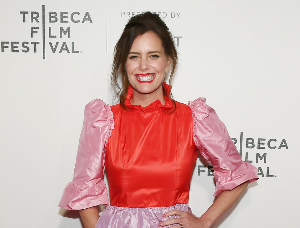 Actress Ione Skye wears a pink and red dress at the screening of 