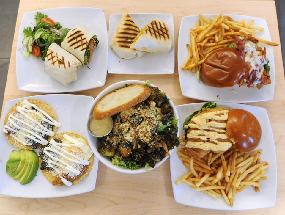 The Kitchen Cafe offers both breakfast and lunch. Photographed are, top, left to right, shiitake wrap, breakfast burrito and crispy chicken sandwich; bottom, left to right, huevos rancheros, brussel sprout salad and crispy fish sandwich. Jayme Valdez and Danielle Panzica opened up the Kitchen Cafe last year after closing their restaurant in Boston's financial district.