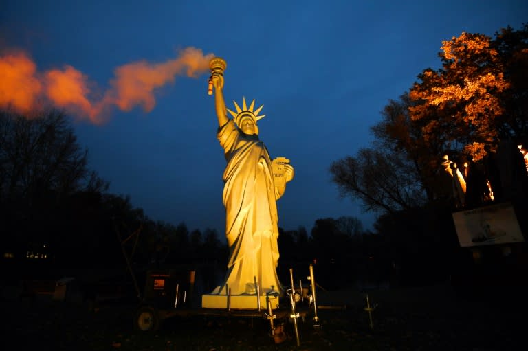 A replica of the Statue of Liberty emitting smoke from the torch, created by Danish artist Jens Galschiot, is displayed at the Rheinaue park during the COP23 United Nations Climate Change Conference in Bonn, Germany on November 16, 2017