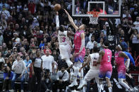 Miami Heat center Bam Adebayo (13) takes a shot against Washington Wizards center Kristaps Porzingis (6) during the second half of an NBA basketball game, Friday, Nov. 25, 2022, in Miami. (AP Photo/Wilfredo Lee)