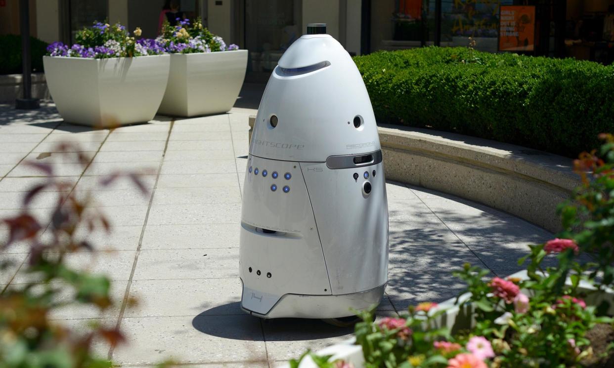 <span>A K5 security robot made by Knightscope patrolling the Stanford shopping center in Palo Alto, California.</span><span>Photograph: Stephen McLaren/The Guardian</span>