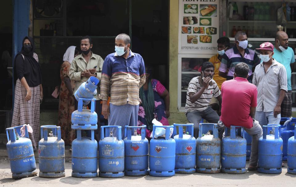 Sri Lankans wait in a queue to buy cooking gas in Colombo, Sri Lanka, Friday, March 25, 2022. Earlier this month, Sri Lanka’s president requested people’s support by limiting electricity and fuel consumption to cope with the worst economic crisis in memory. (AP Photo/Eranga Jayawardena)