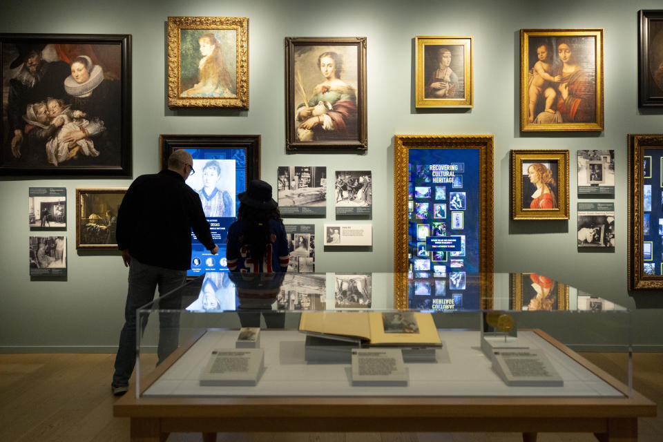 Visitors tour a permanent exhibition about the Monuments Men and Women at The National WWII Museum's Liberation Pavilion in New Orleans, Thursday, Feb. 15, 2024. (AP Photo/Christiana Botic)