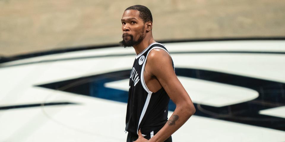 Kevin Durant stands with his hands on his hips during a game in 2021.