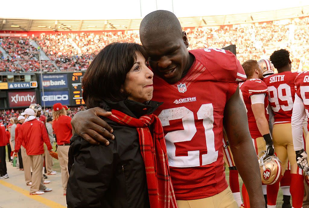 San Francisco 49ers owner Denise York gets a hug from Frank Gore #21 on the sidelines while the 49ers were ahead of the Arizona Cardinals 27-6 late in the fourth quarter at Candlestick Park on December 30, 2012 in San Francisco, California.