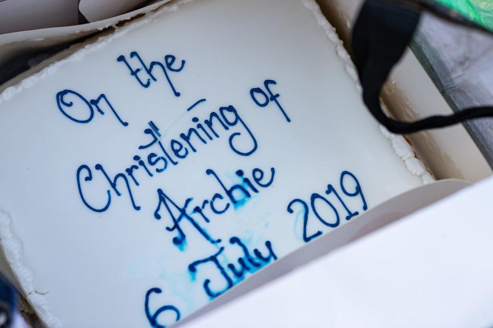 A royal fan presents a cake dedicated to baby Archie's christening.