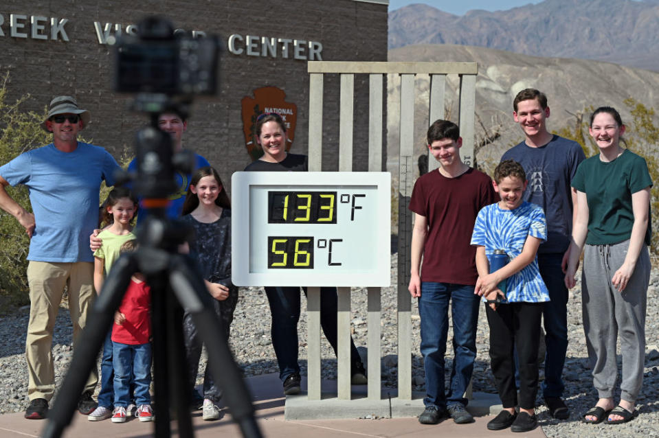 People visit the unofficial thermometer reading 133 degrees Fahrenheit/56 degrees Celsius at Furnace Creek Visitor Center on July 11, 2021 in Death Valley National Park, California.<span class="copyright">David Becker—Getty Images</span>