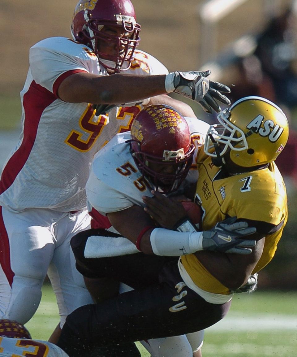 Tuskegee University's DeMarcus Nash, (93), and Marcus Wright, (55) tackle Alabama State University's Tarvaris Jackson, (7), at the Turkey Day Classic at the Cramton Bowl in Montgomery, Ala. Thursday, Nov. 24, 2005. (Montgomery Advertiser, Karen S. Doerr)