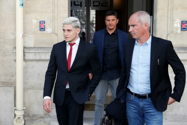 Australian international James O'Connor (L) leaves after appearing before the French National Rugby League (Ligue Nationale de Rugby, LNR) disciplinary commission in Paris on April 12, 2017, after being arrested for cocaine possession