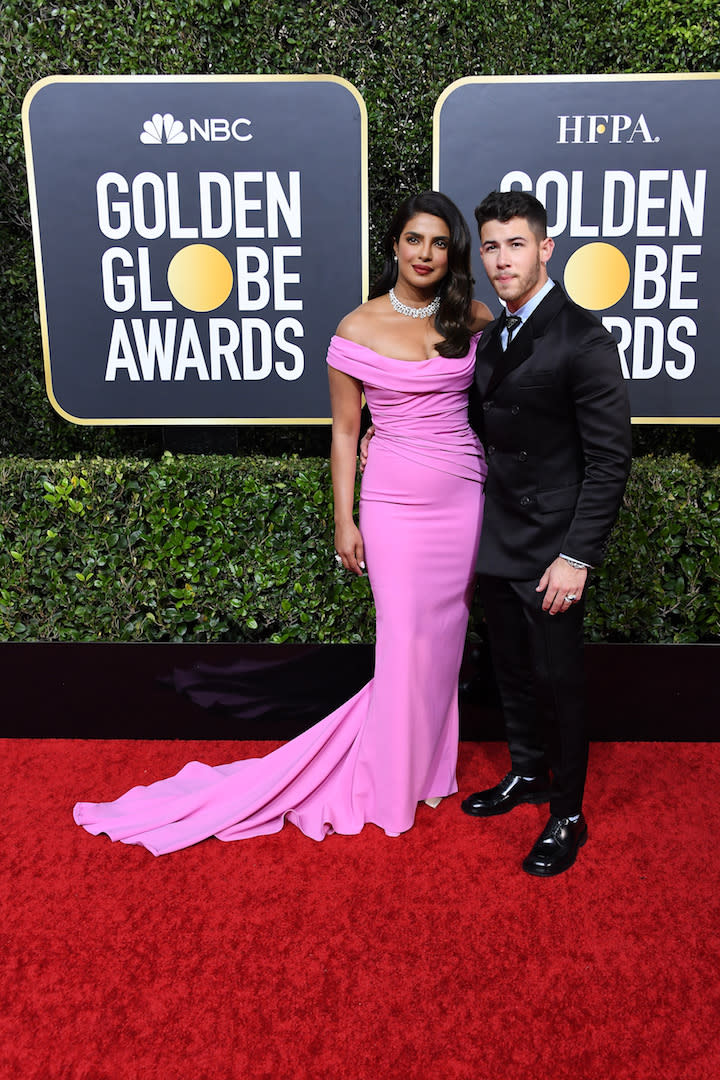 Priyanka Chopra is wearing a Cristina Ottaviano dress accessorised with Bvlgari jewels, Christian Louboutin shoes and a Jimmy Choo bag. Meanwhile, husband Nick Jonas chose a Prada ensemble. <em>[Photo: Getty]</em>