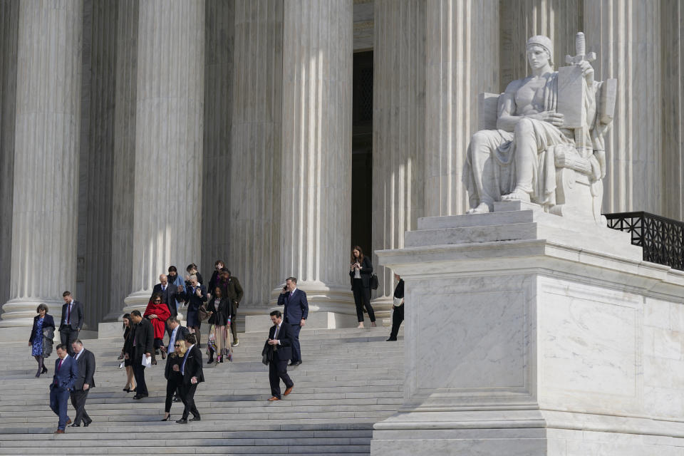 People walk down the Supreme Court steps on Capitol Hill in Washington, Tuesday, Feb. 28, 2023, after the first of two hearings over President Joe Biden's student debt relief plan. (AP Photo/Patrick Semansky)